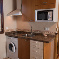 cocina equipada con lavadora y electrodomesticos en alojamiento de llanes